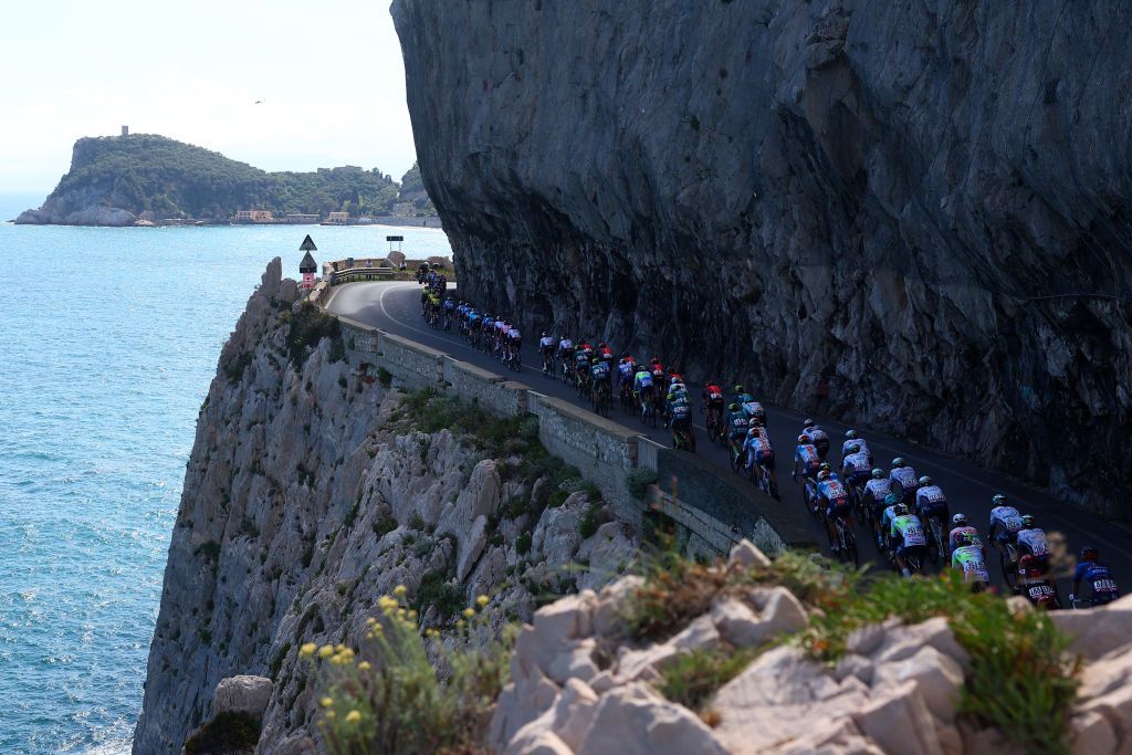 The pack rides at Noli's cape during the 4th stage of the 107th Giro d'Italia cycling race, 190 km between Acqui Terme and Andora, on May 7, 2024 in Noli. (Photo by Luca Bettini / AFP)