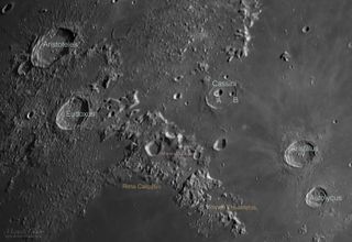 An annotated version of the photo shows the locations of the impact craters and rilles on the moon.
