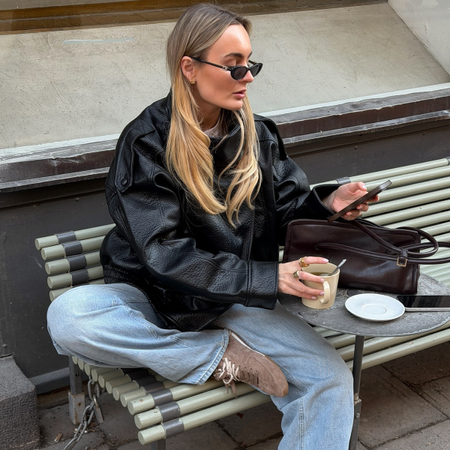 Woman wearing wide leg jeans with spring 2026 shoe trend.