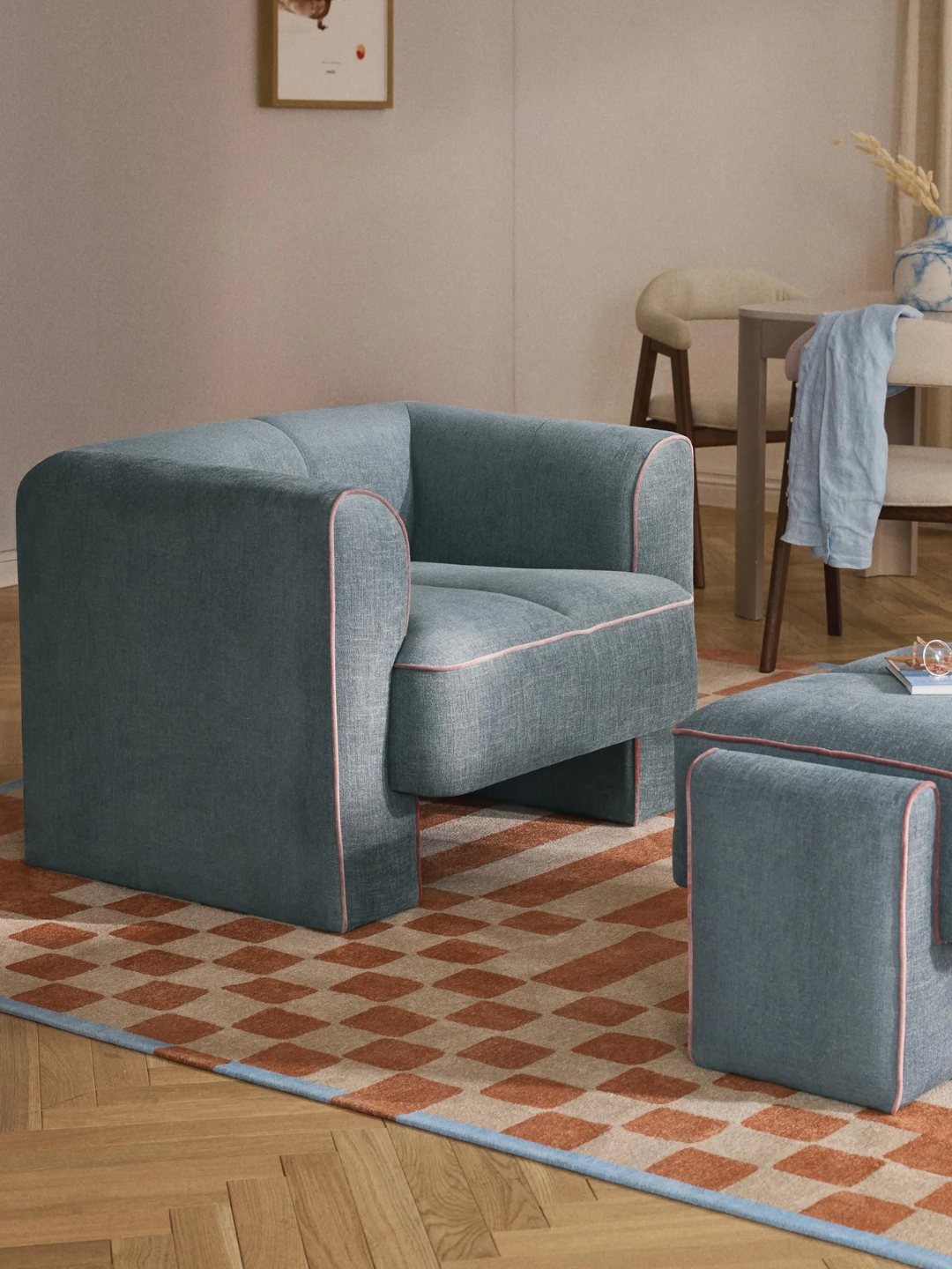 A blue cushy armchair with pink lining from Westwing