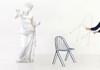 Sculpture with chairs in front of it