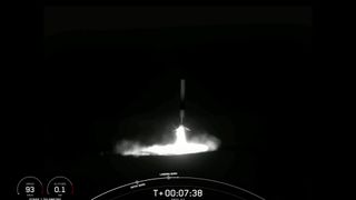 a black and white rocket comes back to earth at night