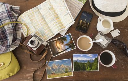 Coffee, photographs and map on table