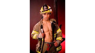 Man poses in fire fighter suit revealing chest