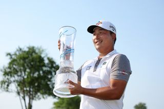 K H Lee holds the AT&T Byron Nelson trophy
