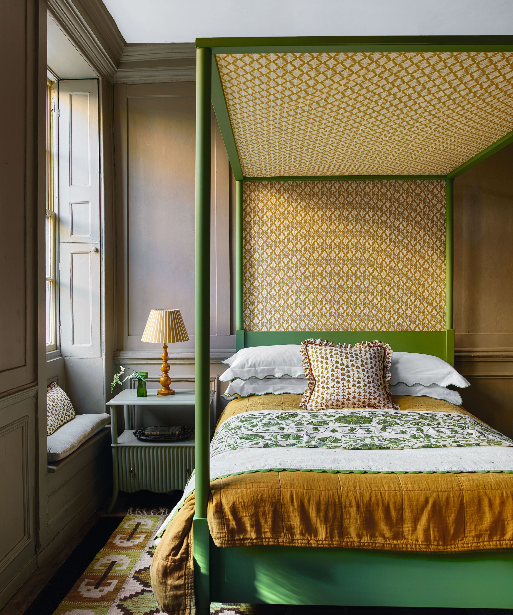 Green brown and yellow bedroom with four poster bed