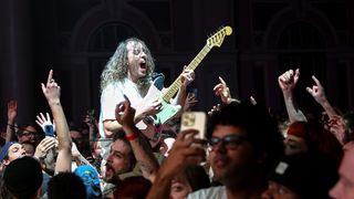 Lee Kiernan of Idles performs live in the crowd at Alexandra Palace on November 30, 2024 in London, England