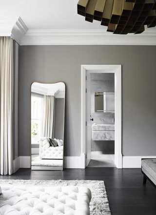 grey bedroom with large wall mirror