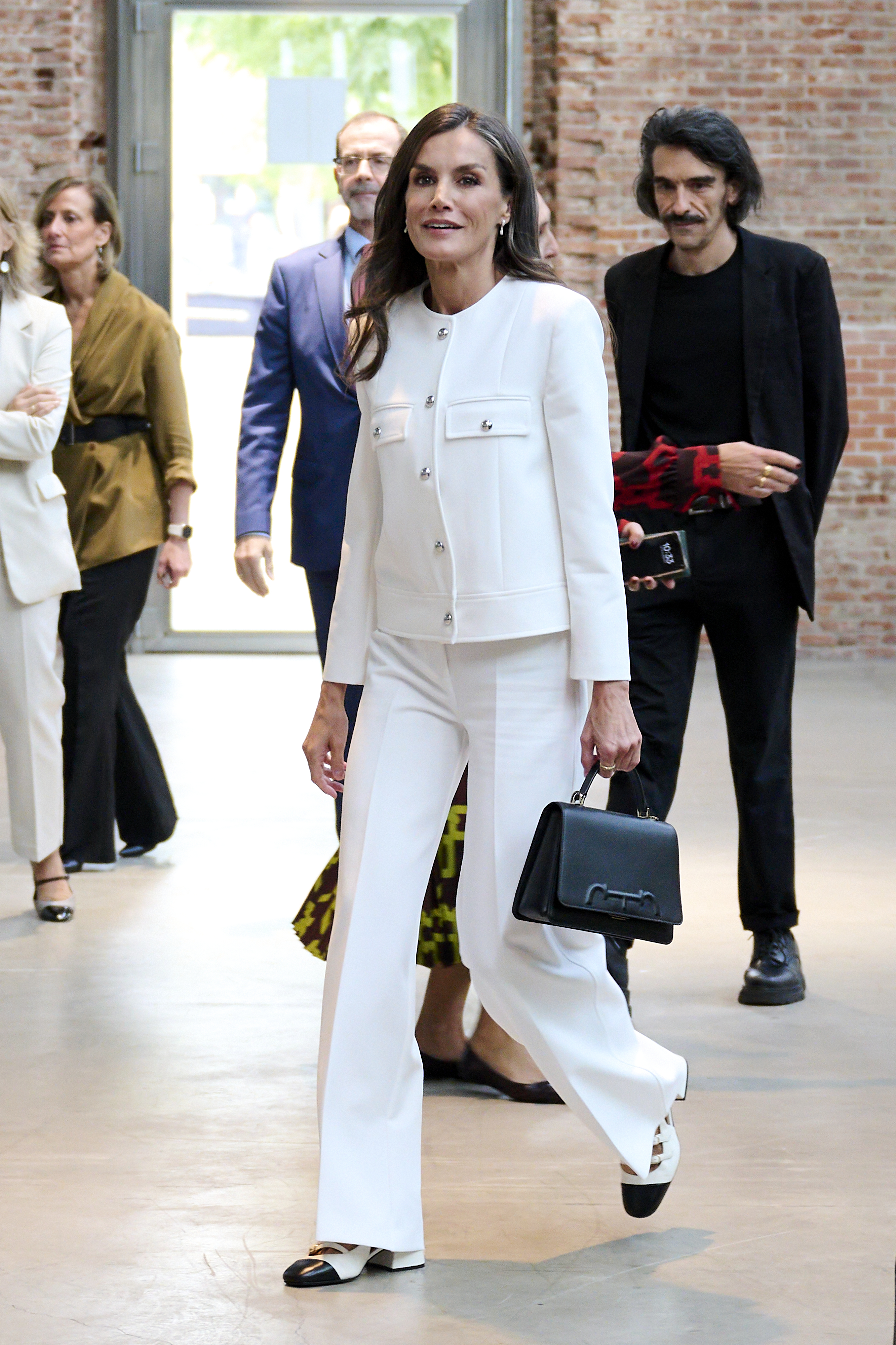 Queen Letizia wearing a white trouser suit