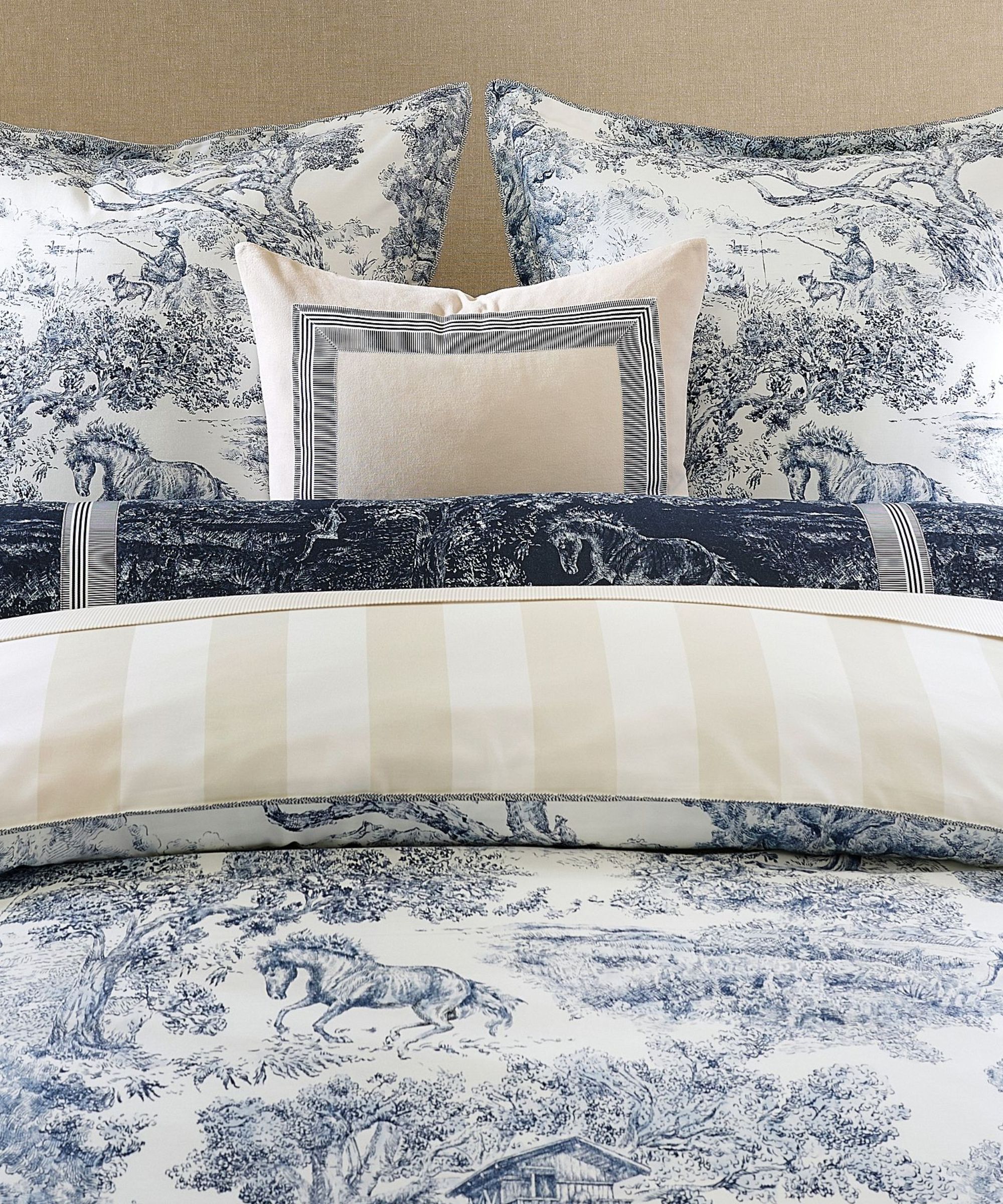 Blue toile bedding with cream reversible stripe print and cream cushion