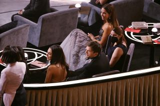 Mila Kunis and Ashton Kutcher sitting during the Oscars 2022.
