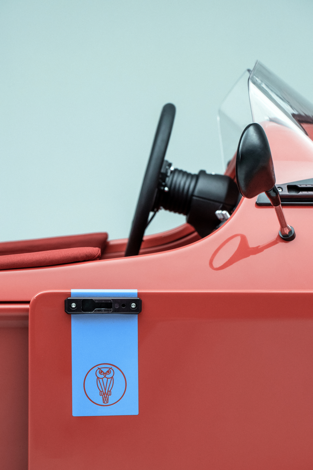Three-wheel sports car exterior with owl detail