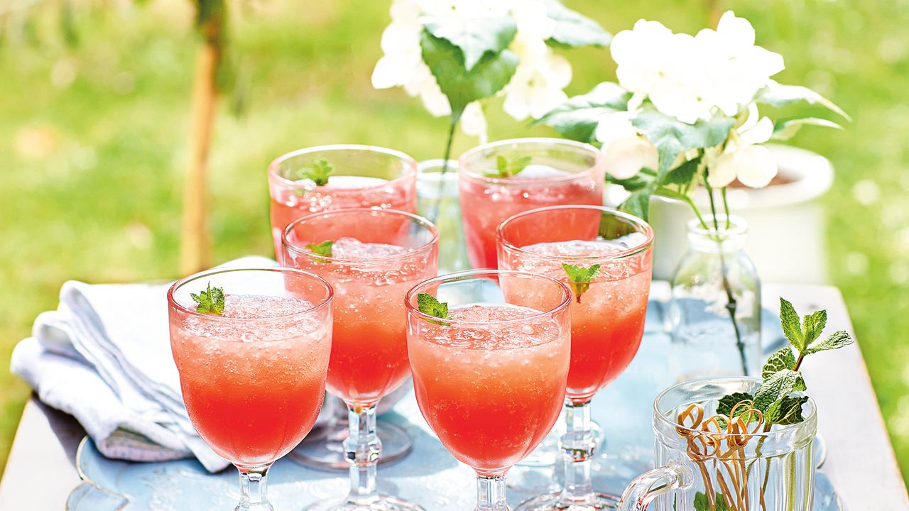 Frose in wine glasses on tray in garden