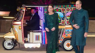 Prince William and Kate Middleton stepping out of a tuk tuk