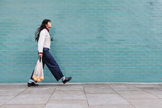 Young woman in London, England, walking around with a reusable bag