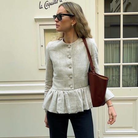 Woman wearing liberowe peplum top in spring 2026.