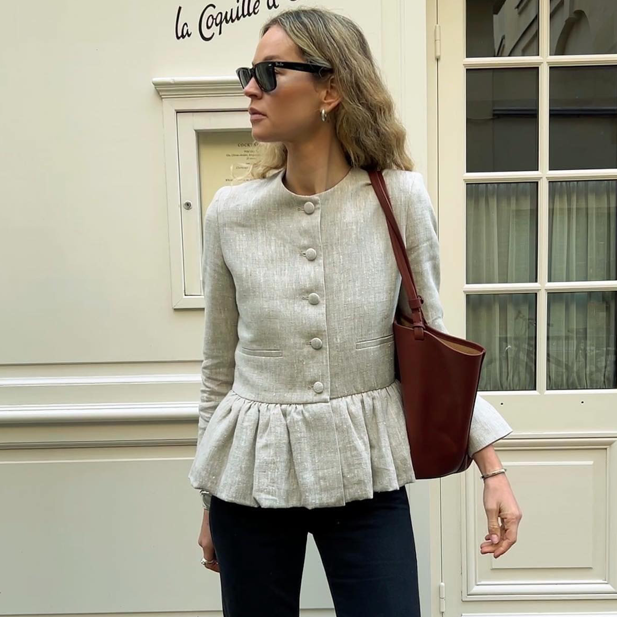 Woman wearing liberowe peplum top in spring 2026.