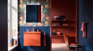 Bright orange bathroom suite with floral wallpaper