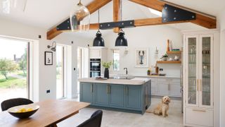 open plan kitchen diner with kitchen island and exposed beams
