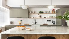 white kitchen with grey cabinets and marble kitchen island