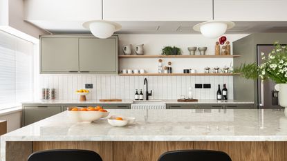 white kitchen with grey cabinets and marble kitchen island