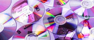 A collection of different digital media storage devices and Tux the Penguin.