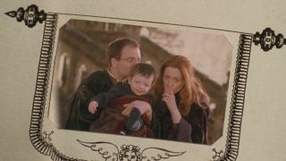 A Photo of James and Lily Potter holding Harry as a baby