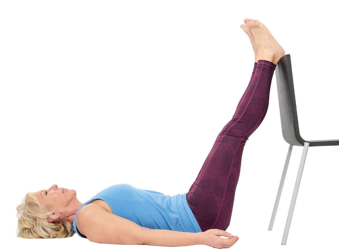 Annie Deadman lies flat on her back with legs up on a chair