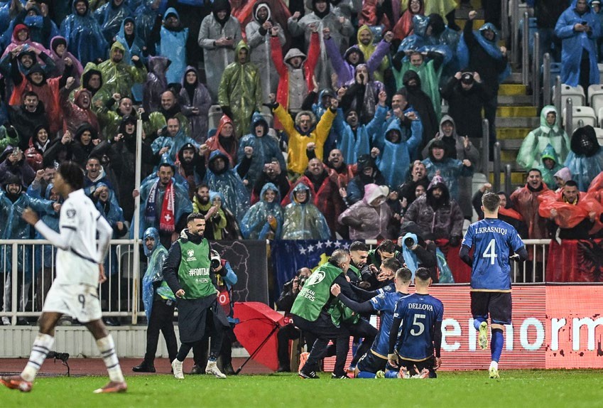 Kosovo's midfielder #08 Florent Muslija (C) celebrates with teammates and supporters after scoring his team's first goal during the FIFA World Cup 2026 European qualification Group B football between Kosovo and Switzerland at the Fadil Vokrri Stadium in Pristina, on November 18, 2025. (Photo by Armend NIMANI / AFP) (Photo by ARMEND NIMANI/AFP via Getty Images)