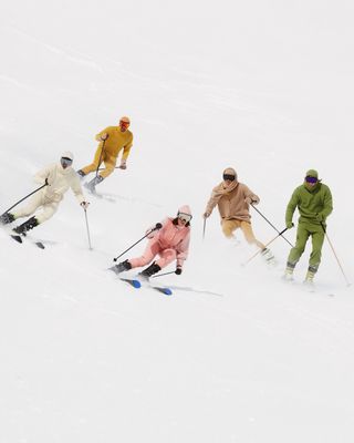 Skiiers on ski slope wearing Extreme Cashmere knitwear