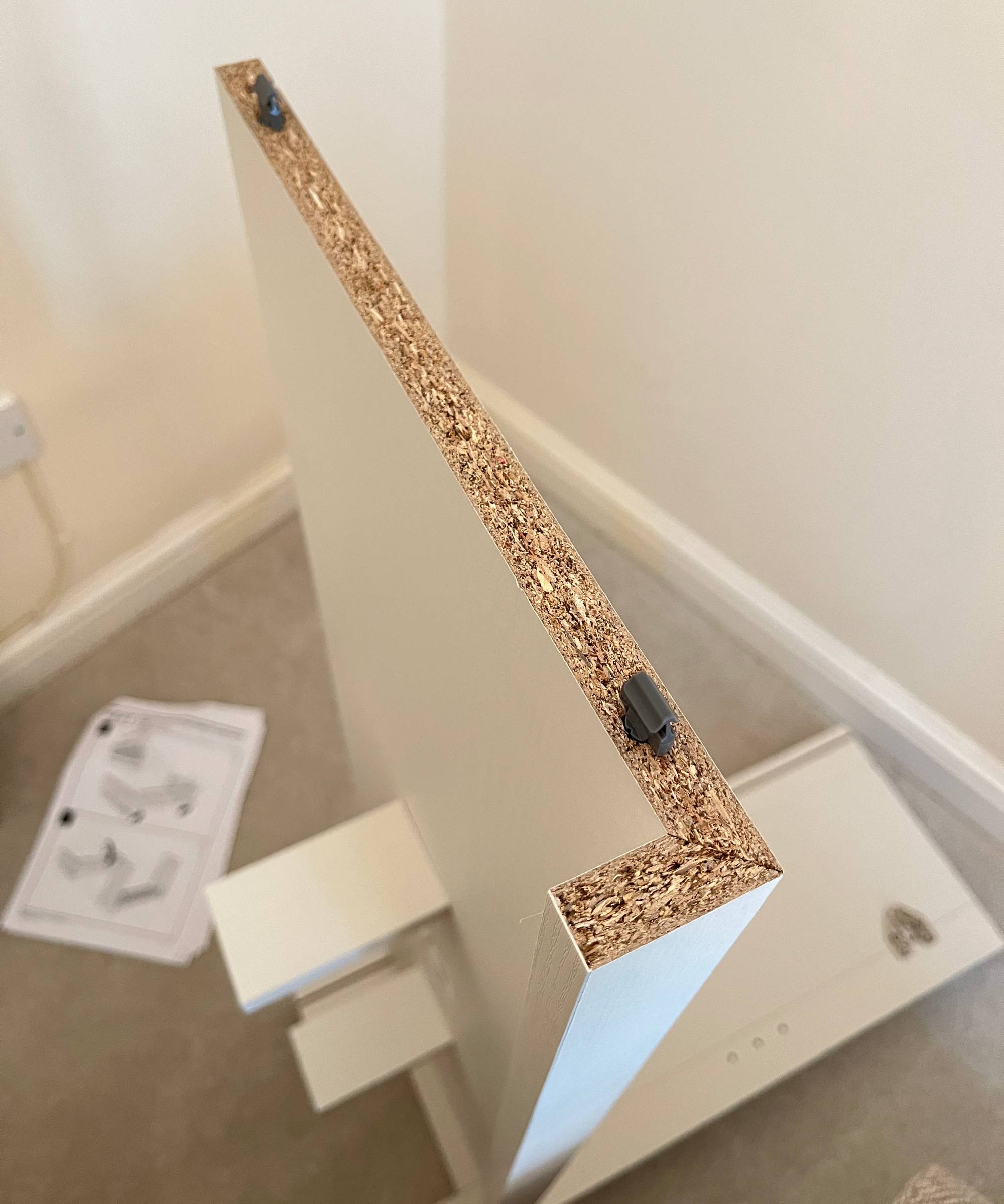 close up of top of shelving unit being assembled