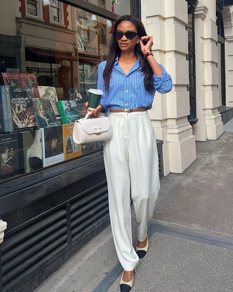 @symphonyofsilk wears cream satin trousers