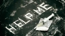 Cocaine spelling out "Help Me" and syringe