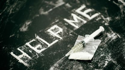 Cocaine spelling out "Help Me" and syringe