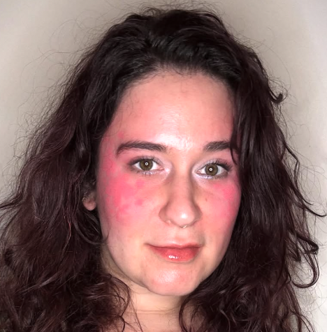 a white woman with lots of pink blush and brown curly hair