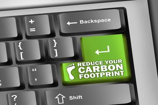 "Reduce your carbon footprint" written on a green key on a computer keyboard.
