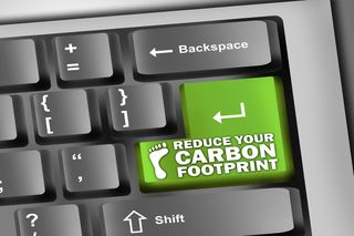 &amp;quot;Reduce your carbon footprint&amp;quot; written on a green key on a computer keyboard.