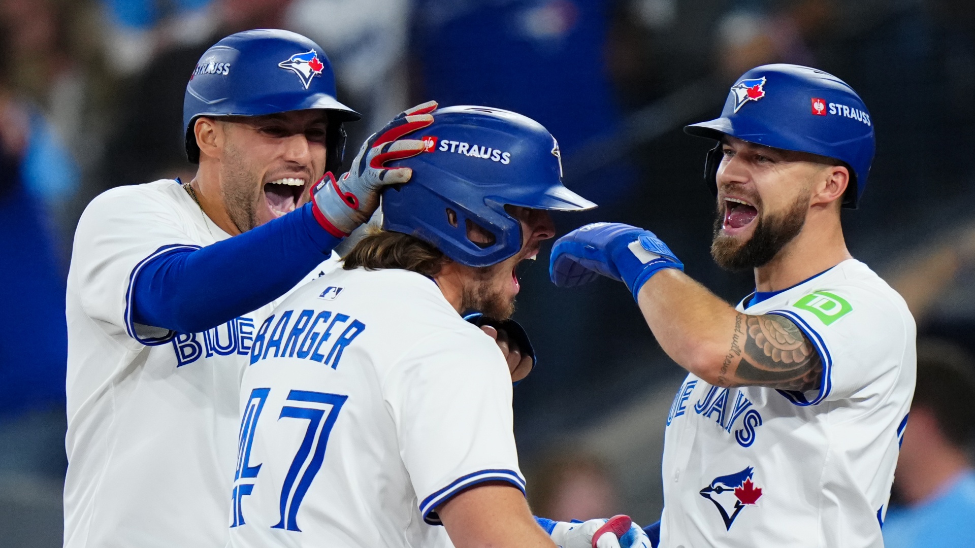 Addison Barger of the Toronto Blue Jays celebrates with George Springer and Nathan Lukes after hitting a grand slam in Game 1 of the 2025 MLB World Series