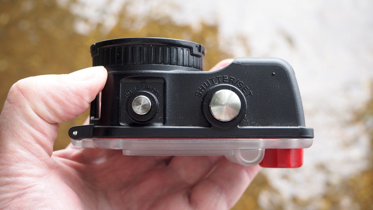 SeaLife ReefMaster RM-4K waterproof camera on a stony waterside