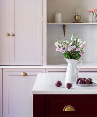 light and dark color contrast kitchen with red island and pink cabinets