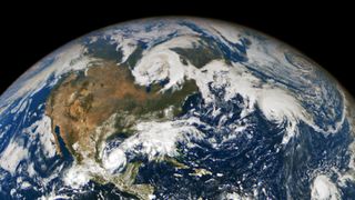 An image from space showing storm clouds across North America and the Atlantic