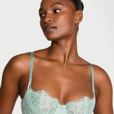 Woman wearing teal blue lace Victoria Secret bra