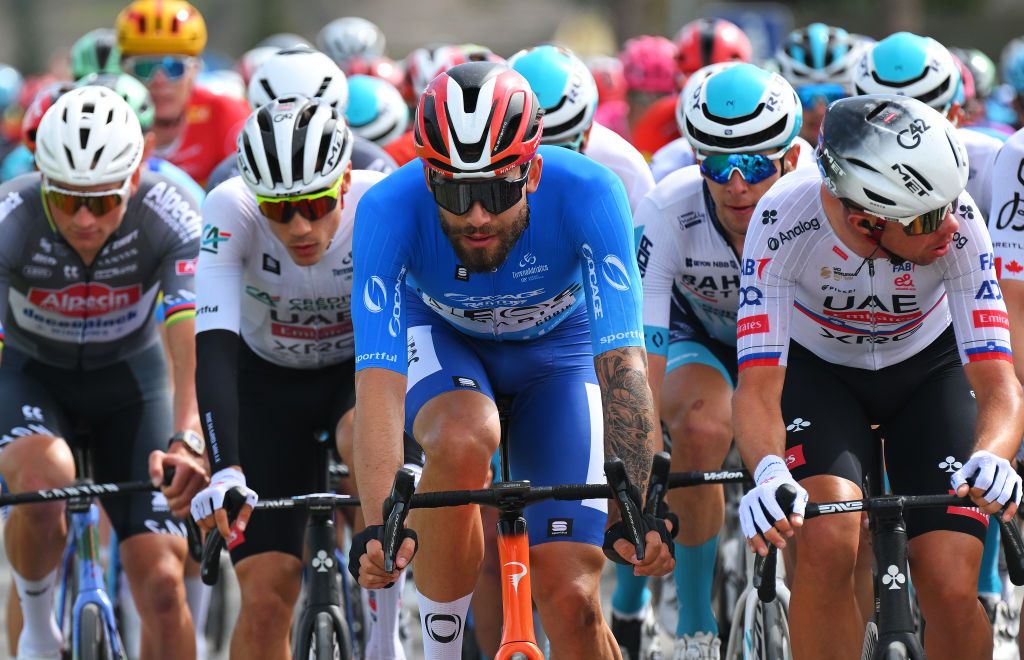 Filippo Ganna (Ineos Grenadiers) riding in the peloton in the blue leader&#039;s jersey