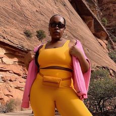 a woman wearing an orange workout set
