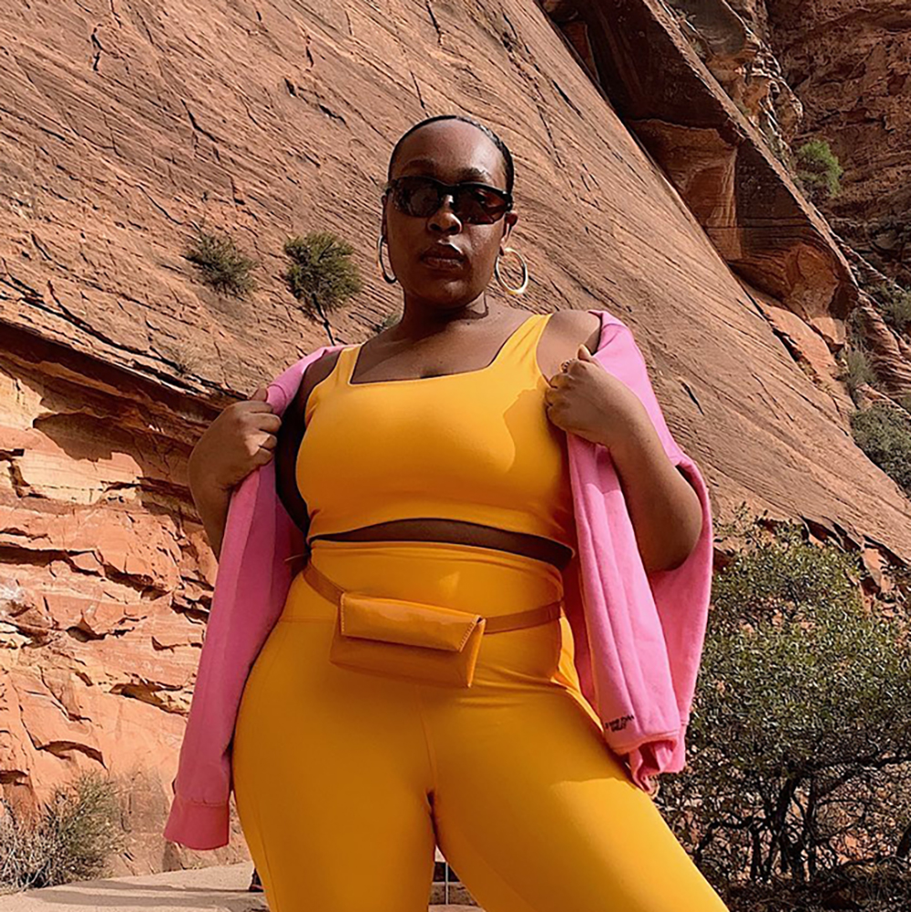 a woman wearing an orange workout set
