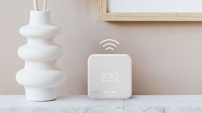 Tado smart thermostat on a marble shelf