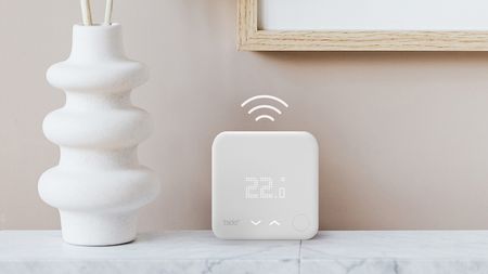 Tado smart thermostat on a marble shelf