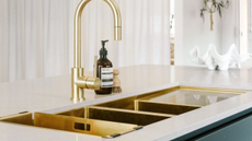 gold hardware sink with a matching in-sink colander within