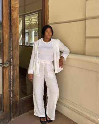 @simplytandya wearing a white linen shirt and trousers