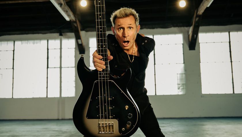 Mike Dirnt poses in a publicity for the Mike Dirnt Epiphone Grabber Bass. The example he&#039;s holding has a Silverburst finish. 